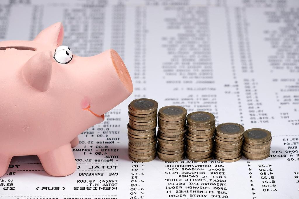 Stack of coins and a piggy bank representing savings